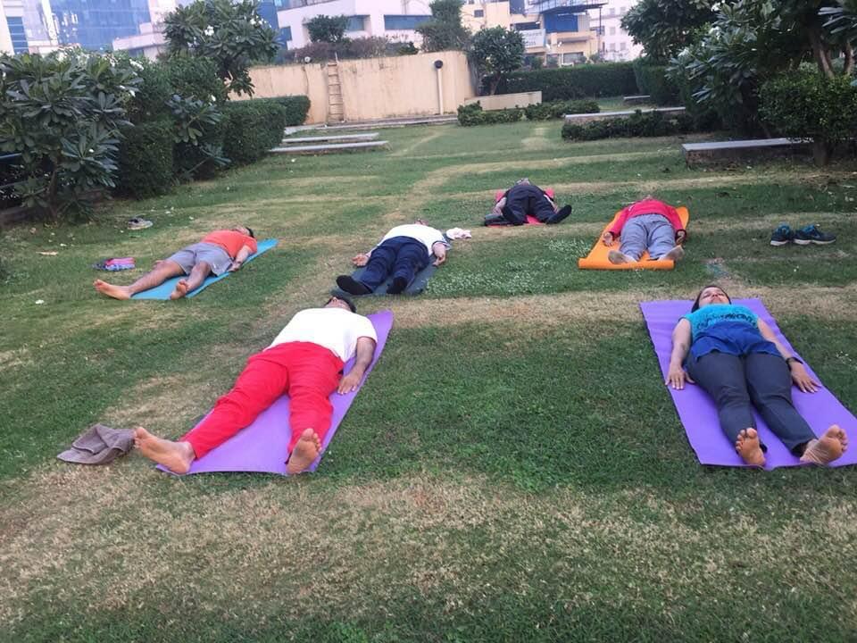Group shavasana guided relaxation on lawn mats